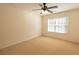 Bright bedroom with a ceiling fan, neutral carpet, and a large window for ample natural light at 480 Glenns Farm Way, Grayson, GA 30017