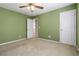 Spacious bedroom featuring carpet floors, a ceiling fan, and an entrance to another room at 480 Glenns Farm Way, Grayson, GA 30017