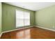 A simple bedroom with hardwood flooring and a window that lets in plenty of natural light at 480 Glenns Farm Way, Grayson, GA 30017