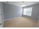 Bedroom featuring gray walls, carpet, a window, and a door at 480 Glenns Farm Way, Grayson, GA 30017