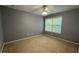 Gray bedroom with carpet flooring, a ceiling fan, and a window with blinds at 480 Glenns Farm Way, Grayson, GA 30017