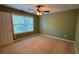 Olive green bedroom with carpet flooring, a window with blinds, and a ceiling fan at 480 Glenns Farm Way, Grayson, GA 30017