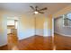 Dining room with hardwood floors, wainscoting, ceiling fan, and view to the kitchen and staircase at 480 Glenns Farm Way, Grayson, GA 30017