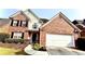 Charming two-story brick home featuring a two-car garage and manicured landscaping at 480 Glenns Farm Way, Grayson, GA 30017