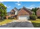 Charming two-story brick home with well-manicured lawn and attached two-car garage at 480 Glenns Farm Way, Grayson, GA 30017