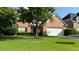 Charming brick home featuring a two-car garage, manicured lawn, and mature tree in front yard at 480 Glenns Farm Way, Grayson, GA 30017
