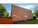 Side exterior view of brick home with fenced yard and green space at 480 Glenns Farm Way, Grayson, GA 30017