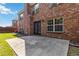 Exterior shot revealing brick facade, backyard patio, and well-maintained lawn at 480 Glenns Farm Way, Grayson, GA 30017