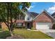 Charming two-story brick home with well-manicured lawn and attached two-car garage at 480 Glenns Farm Way, Grayson, GA 30017