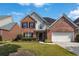 Charming two-story brick home with well-manicured lawn and attached two-car garage at 480 Glenns Farm Way, Grayson, GA 30017