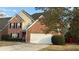 Charming two-story brick home featuring a two-car garage, well-maintained lawn and lush landscaping at 480 Glenns Farm Way, Grayson, GA 30017