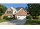 Beautiful two-story home with brick facade, black shutters, attached two-car garage, and well-maintained lawn at 480 Glenns Farm Way, Grayson, GA 30017