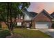 Charming two-story brick home with well-manicured lawn and attached two-car garage at 480 Glenns Farm Way, Grayson, GA 30017