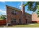 Back exterior view highlighting brick, a tall chimney, and neat landscaping at 480 Glenns Farm Way, Grayson, GA 30017