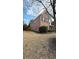 An exterior view of the two-story home featuring a red brick facade and front yard at 480 Glenns Farm Way, Grayson, GA 30017