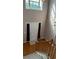 Sun-filled foyer with hardwood floors, a staircase, and a view of the front door at 480 Glenns Farm Way, Grayson, GA 30017