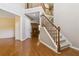 Open-concept foyer with hardwood floors, staircase, and views into adjoining living spaces at 480 Glenns Farm Way, Grayson, GA 30017