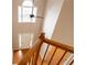 View from the top of the staircase to the bright foyer with a high window and hardwood floors at 480 Glenns Farm Way, Grayson, GA 30017