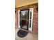 Elegant front door with glass insert, sidelight window, brick surround, and decorative exterior lighting at 480 Glenns Farm Way, Grayson, GA 30017