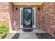 Close-up of a brick home's elegant front door with sidelights and decorative transom window at 480 Glenns Farm Way, Grayson, GA 30017