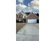 Inviting two-story home features a brick facade, attached garage, well-maintained lawn, and neutral siding at 480 Glenns Farm Way, Grayson, GA 30017