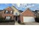 Charming two-story brick home with attached two-car garage, black shutters, and manicured landscaping at 480 Glenns Farm Way, Grayson, GA 30017