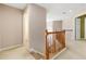Upstairs hallway with carpet and wood railing at 480 Glenns Farm Way, Grayson, GA 30017