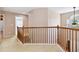 Second floor hallway with wood railing and carpet at 480 Glenns Farm Way, Grayson, GA 30017