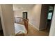 Upstairs hallway featuring carpet flooring, neutral paint, and a wooden railing at 480 Glenns Farm Way, Grayson, GA 30017