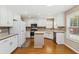 Bright kitchen with white cabinetry, stainless steel appliances, and island at 480 Glenns Farm Way, Grayson, GA 30017