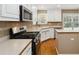 Modern kitchen features stainless steel appliances and countertops with a neutral backsplash at 480 Glenns Farm Way, Grayson, GA 30017