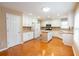 Bright kitchen with an island, white cabinets, stainless steel microwave and plenty of counter space at 480 Glenns Farm Way, Grayson, GA 30017