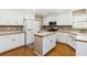 Well-lit kitchen featuring white cabinetry, stainless appliances, and island at 480 Glenns Farm Way, Grayson, GA 30017