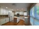 Bright kitchen with recessed lighting, white cabinets, wood countertops, stainless steel appliances, and island at 480 Glenns Farm Way, Grayson, GA 30017