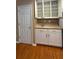 Kitchen cabinet with countertop and storage space, adjacent to a pantry and a white door at 480 Glenns Farm Way, Grayson, GA 30017