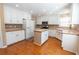 Bright kitchen features an island, white cabinets, and stainless steel appliances at 480 Glenns Farm Way, Grayson, GA 30017