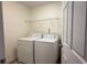 Laundry room featuring a white washer and dryer with overhead wire shelving at 480 Glenns Farm Way, Grayson, GA 30017
