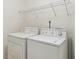 Well-lit laundry room with a pair of white, stacked washer and dryer units at 480 Glenns Farm Way, Grayson, GA 30017