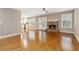 Open living room boasts hardwood floors and a cozy brick fireplace at 480 Glenns Farm Way, Grayson, GA 30017