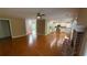 Open-concept living space showcasing hardwood floors and seamless flow into the kitchen with white cabinetry at 480 Glenns Farm Way, Grayson, GA 30017