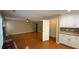Spacious living room with hardwood flooring, fireplace, and access to pantry and cabinetry at 480 Glenns Farm Way, Grayson, GA 30017
