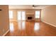 Open living room with hardwood floors, a fireplace, and French doors to an outdoor area at 480 Glenns Farm Way, Grayson, GA 30017