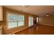 Bright living room featuring hardwood floors, a brick fireplace, and natural light streaming through large windows at 480 Glenns Farm Way, Grayson, GA 30017