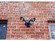 Close up of a security light on a red brick home exterior at 480 Glenns Farm Way, Grayson, GA 30017