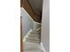 Carpeted staircase featuring a wooden handrail and ambient lighting for a modern touch at 480 Glenns Farm Way, Grayson, GA 30017
