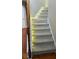 Carpeted staircase with wooden handrail and soft, ambient lighting for a modern feel at 480 Glenns Farm Way, Grayson, GA 30017