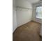 A walk-in closet featuring carpeted floors, a window, and wire shelving at 480 Glenns Farm Way, Grayson, GA 30017