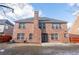 Two-story back exterior shows brick, chimney, windows, door, and patio at 480 Glenns Farm Way Way, Grayson, GA 30017