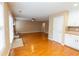 Open-concept living room showing hardwood floors, fireplace and seamless access to the kitchen and backyard at 480 Glenns Farm Way Way, Grayson, GA 30017