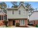 Charming two-story home with a brick facade, gray siding, and well-maintained landscaping at 4893 Autumn Cir, Stone Mountain, GA 30088